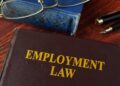 Employment law book symbolizing the role of an unlawful termination attorney in protecting employee rights.