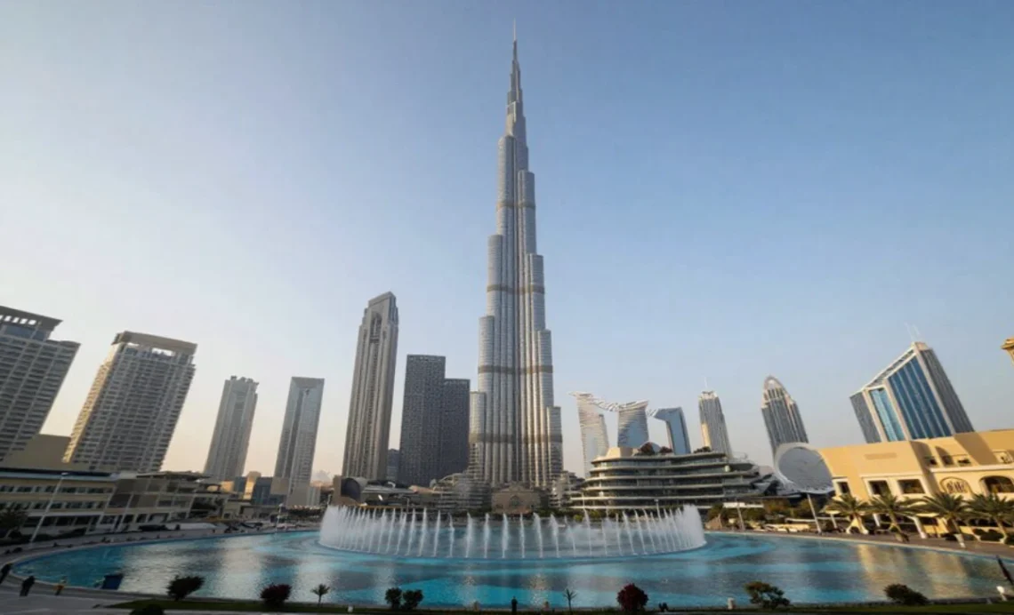 Dubai skyline featuring Burj Khalifa tower, Dubai Fountain, Palm Jumeirah, and modern skyscrapers with desert landscape