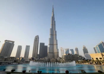 Dubai skyline featuring Burj Khalifa tower, Dubai Fountain, Palm Jumeirah, and modern skyscrapers with desert landscape