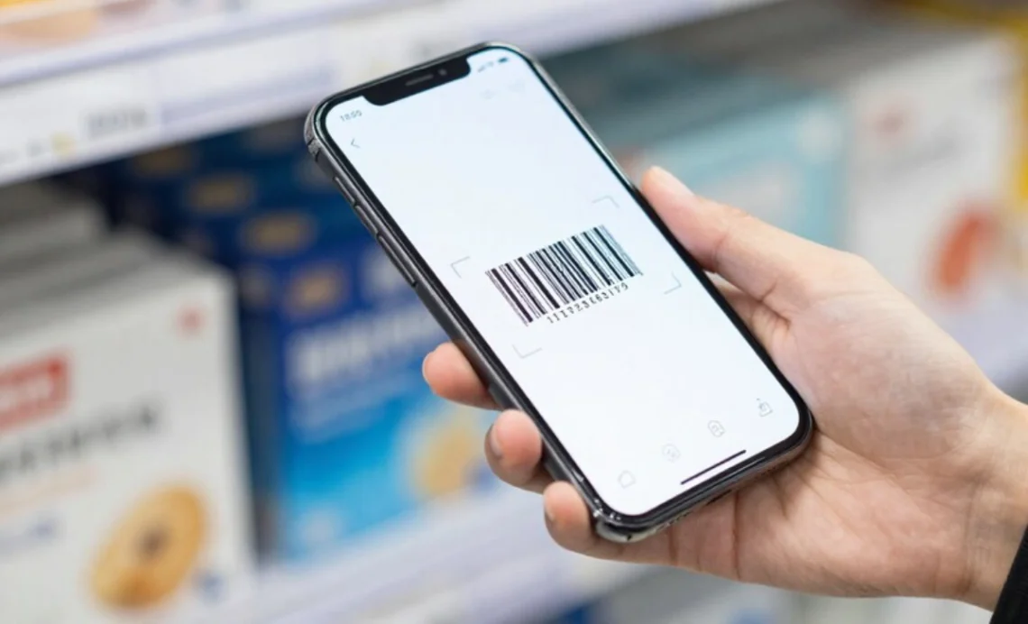 Smartphone camera scanning product barcode with mobile technology showing instant digital information access