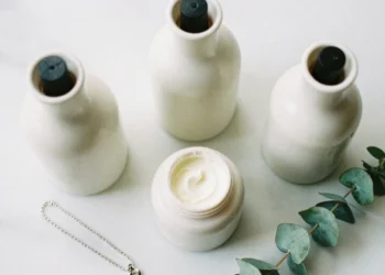 Best neck creams for anti-aging in a modern minimalist flat lay composition with skincare products and a necklace.