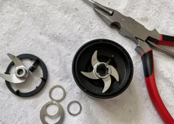Close-up, professional photo showing how to sharpen Nutribullet blades, with disassembled parts and sharpening tools laid out on a clean surface.
