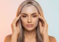 Woman wearing a natural-looking frontal wig with realistic lace front hairline blending seamlessly into her skin